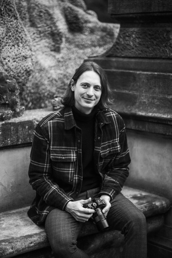Corporate photographer Prague holding a camera in his hands